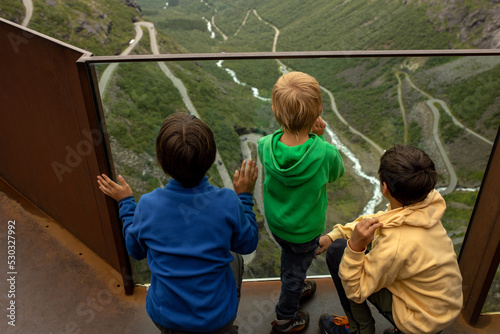 Family, visiting the famous Trollstigen road in Norway photo