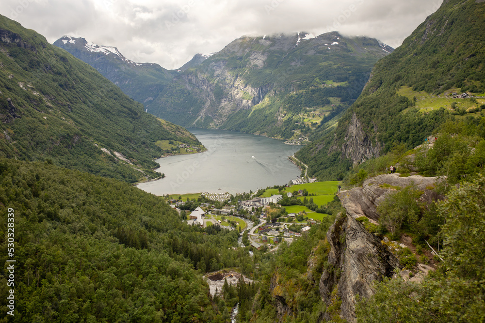 Family, kids and adults and a pet dog, enjoying trip to Geirangerfjord, amazing nature in Norway