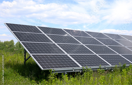 solar panels on blue sky and sun
