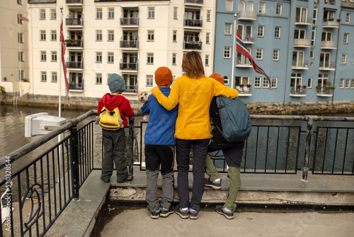 Family, kids, adults and dog, enjoying family vacation in Alesund, beautiful city in Norway