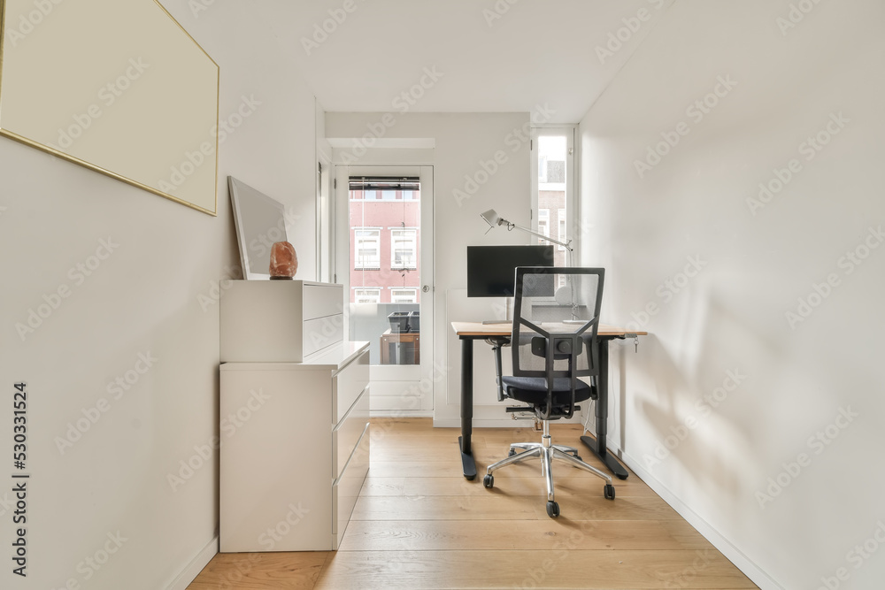 Room with a desk next to a window Room with a desk next to a window