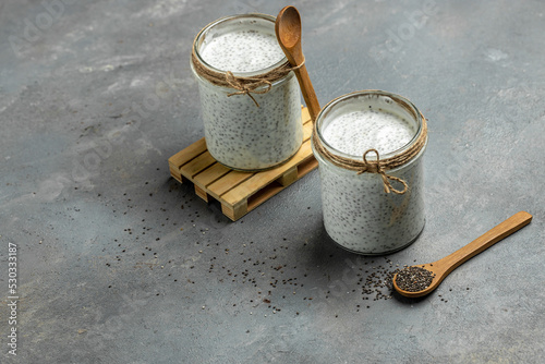 Healthy breakfast. Chia seed pudding. Yogurt with chia seeds healthy superfood. Cottage cheese smoothie in glass jars. place for text