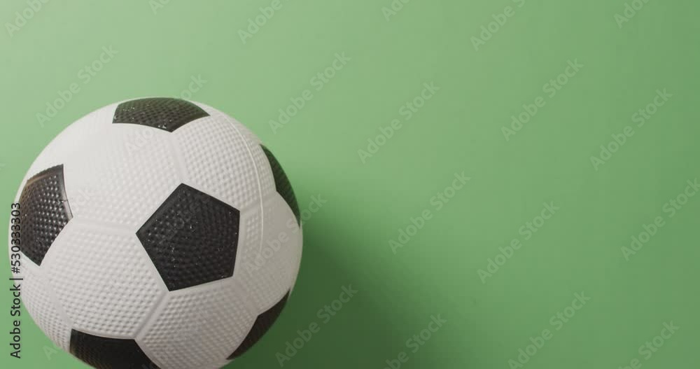 Animation of football over green background with copy space Animation of football over green background with copy space