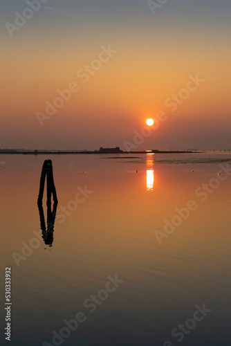 Sunset in the Venice lagoon, silhouette of islands in the background