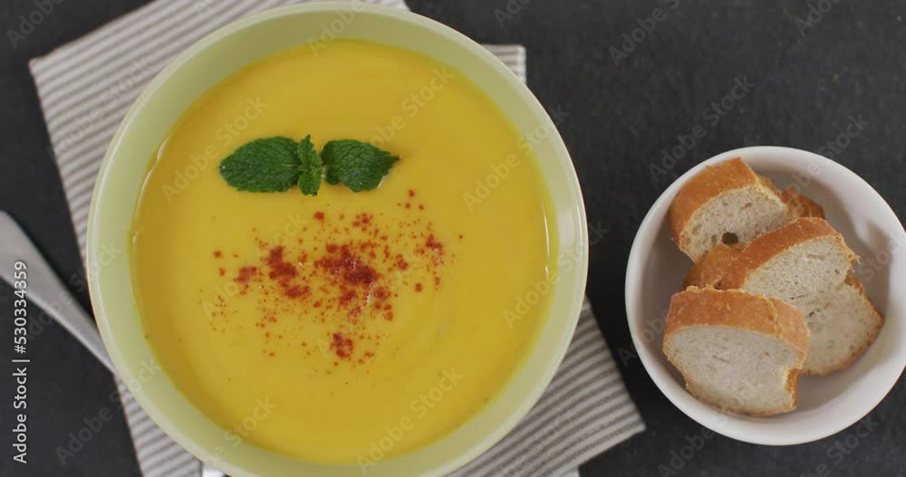 Video of cream vegetable soup in bowl on grey table with bread Video of cream vegetable soup in bowl on grey table with bread