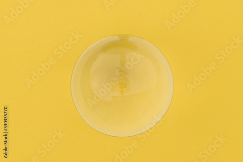 glass sphere on yellow background photo