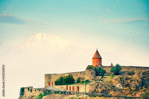 Cinematic view historical landmark in Armenia - Khor Virap monastery with Ararat mountain peak background at sunrise