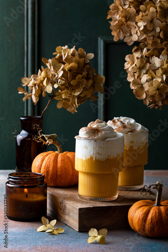 Spicy pumpkin latte with whipped cream. Autumn or winter hot coffee drink with cinnamon  nutmeg