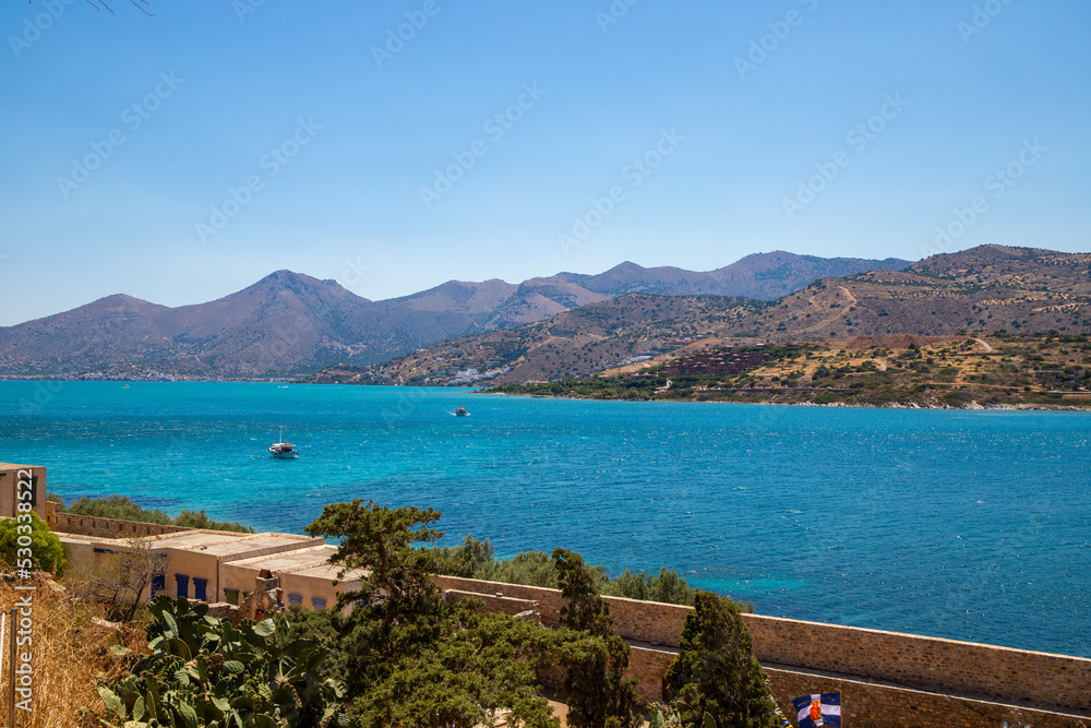 Turquoise blue sea panoramic view with a mountain in the background