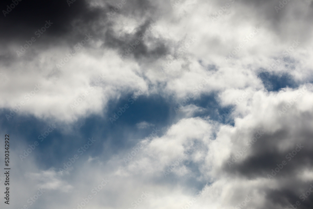 atmosphere storm clouds with pieces of blue sky background