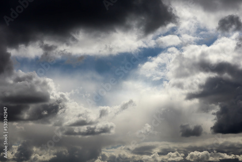 atmosphere storm clouds with pieces of blue sky background