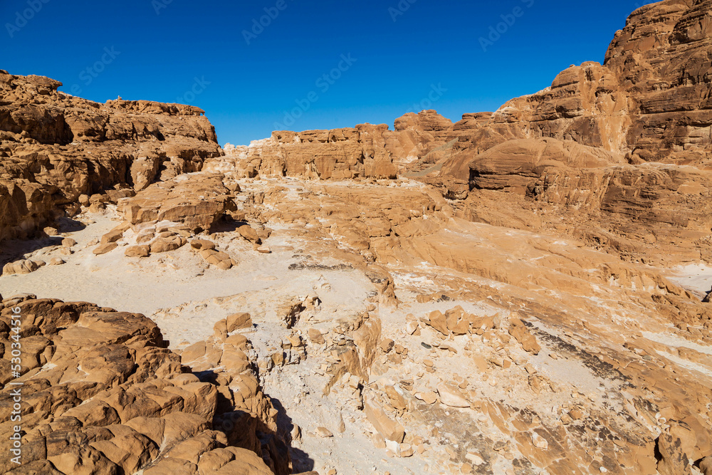 White Canyon in Sinai. Yellow and orange sandstone textured carved mountain, bright blue sky. Egyptian desert landscape. Sinai peninsula, Egypt White Canyon in Sinai. Yellow and orange sandstone textured carved mountain, bright blue sky. Egyptian desert landscape. Sinai peninsula, Egypt