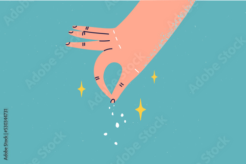 Person adding spices to food 