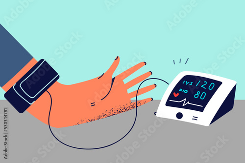 Person do checkup with blood pressure monitor
