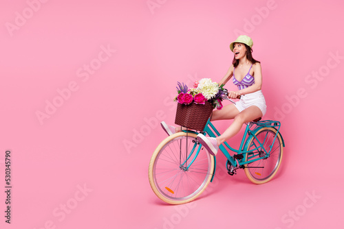 Full length photo of impressed shocked lady wear purple bra riding bicycle empty space isolated pink color background © deagreez