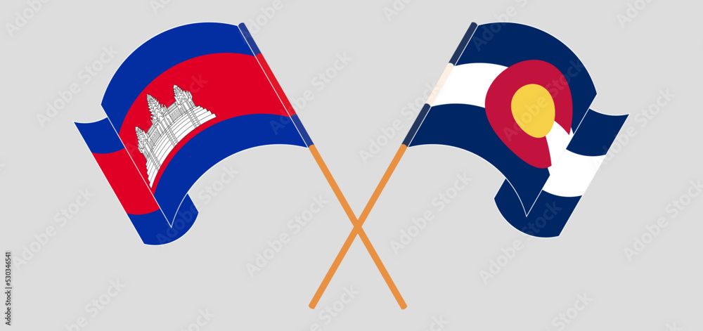 Crossed and waving flags of Cambodia and The State of Colorado