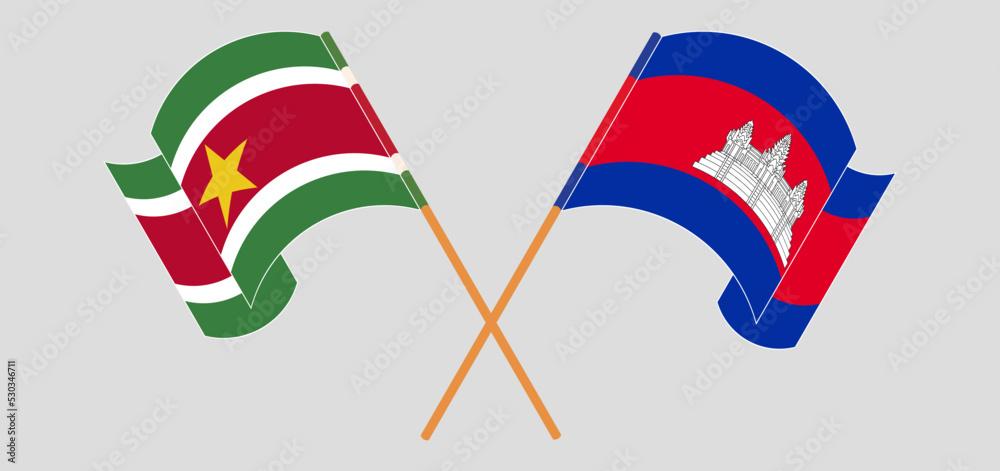 Crossed and waving flags of Suriname and Cambodia