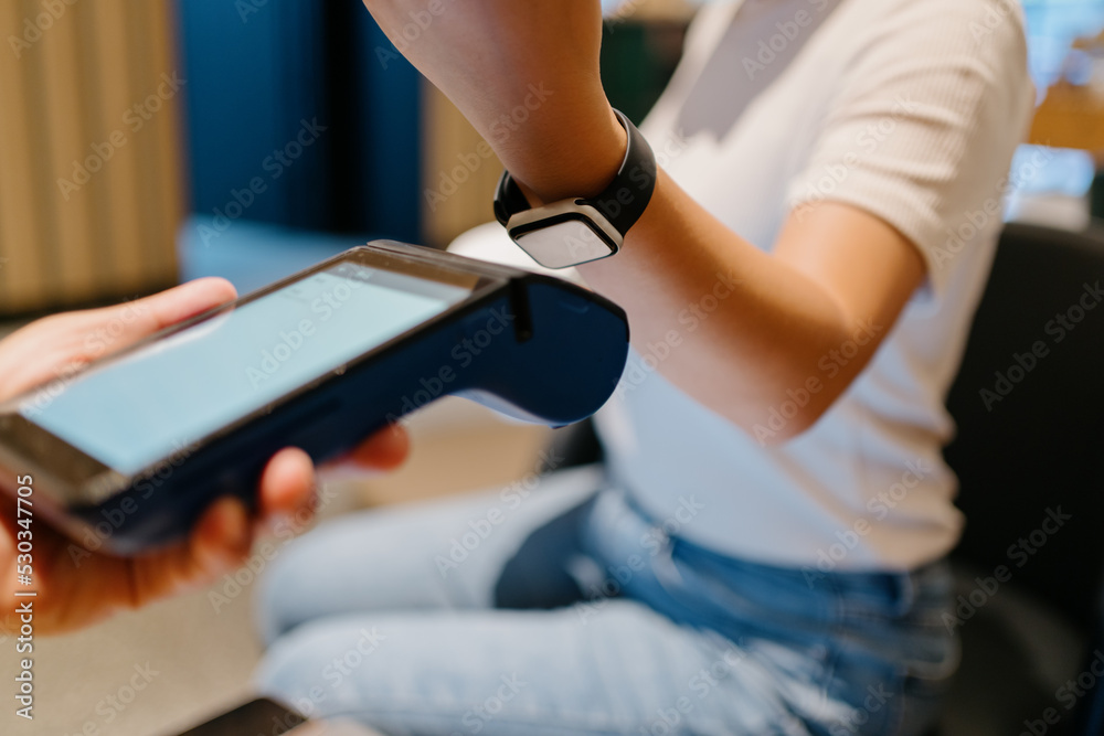 woman pay with smart watch