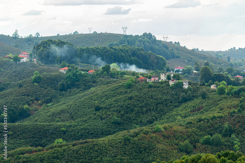 Small village and stubble burning on top of mountain in Sakarya, Turkey