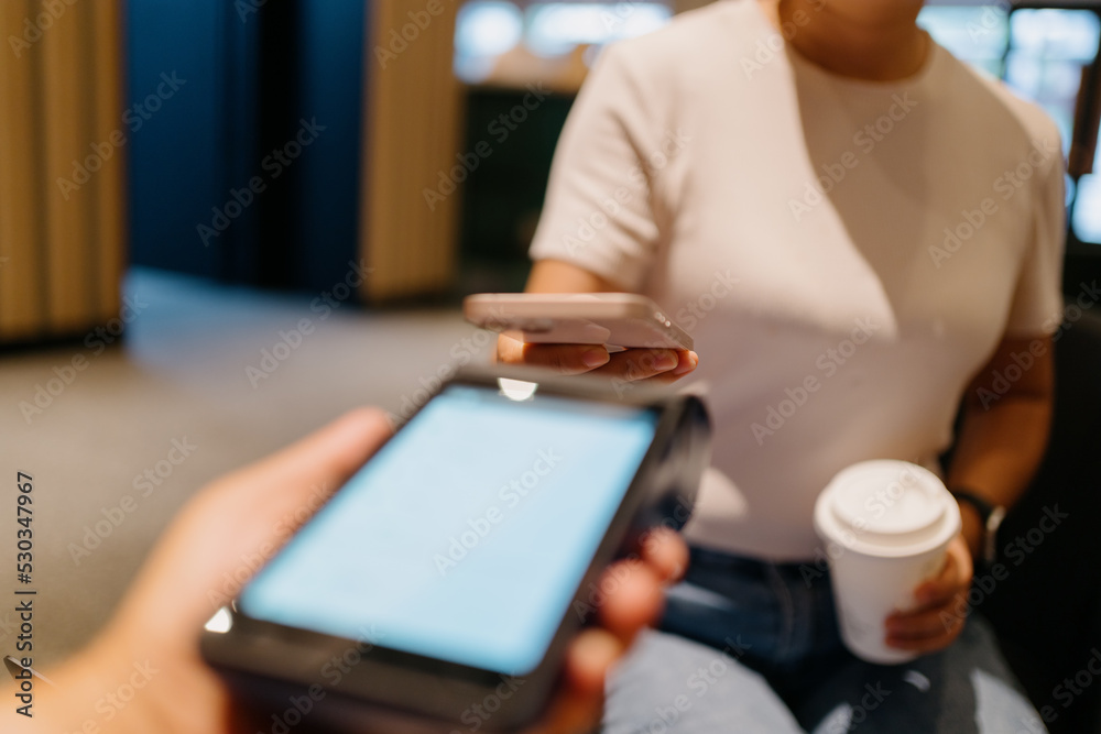 woman pay with smartphone