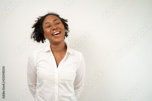 Young lovely African woman laugh and smile happy positive pose with copy space as advertising on white background as positive post