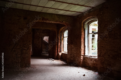 Abandoned old red brick building inside, windows without glasses