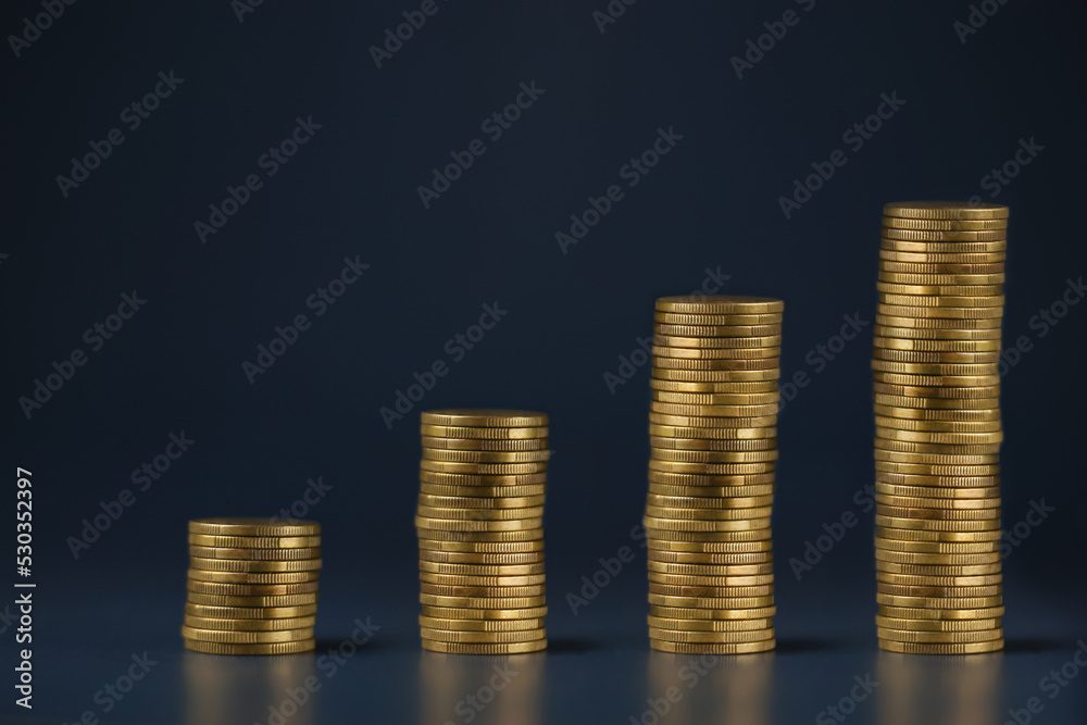 Stacked coins on a dark blue background. Growth investment concept Stacked coins on a dark blue background. Growth investment concept