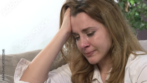 Sad woman crying on the couch