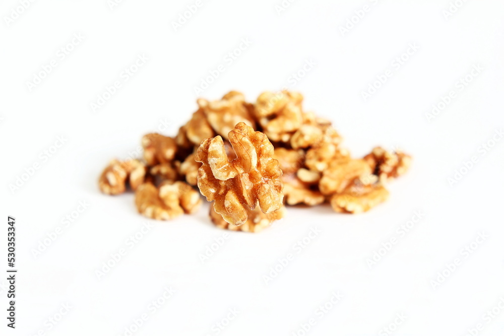 brown organic peeled walnut also known as akhrot in india closeup isolated in blur heap background on white background brown organic peeled walnut also known as akhrot in india closeup isolated in blur heap background on white background