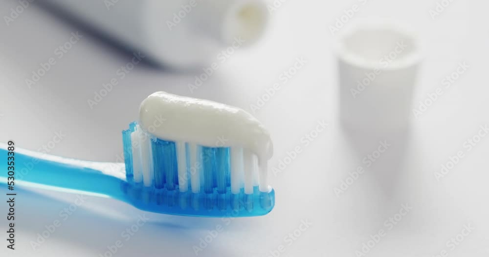 Video of close up of toothbrush and paste on white background Video of close up of toothbrush and paste on white background