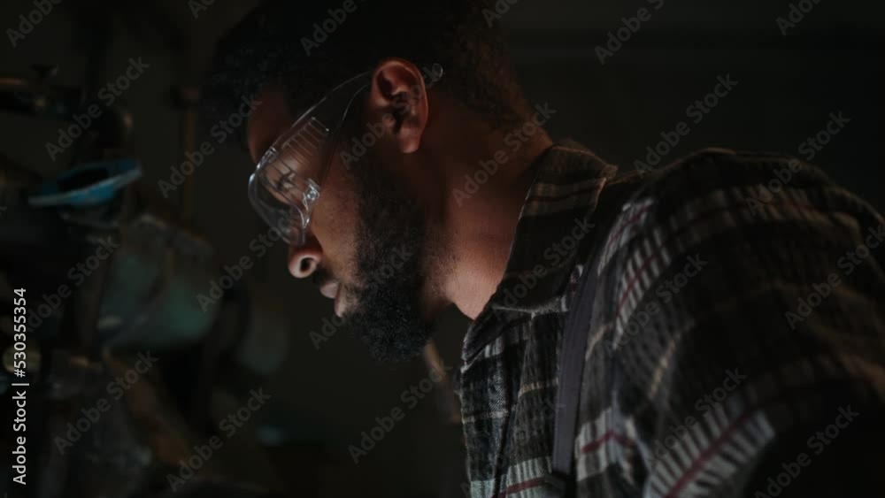 Heavy industry worker in safety glasses concentrating on work. Heavy industry worker in safety glasses concentrating on work.