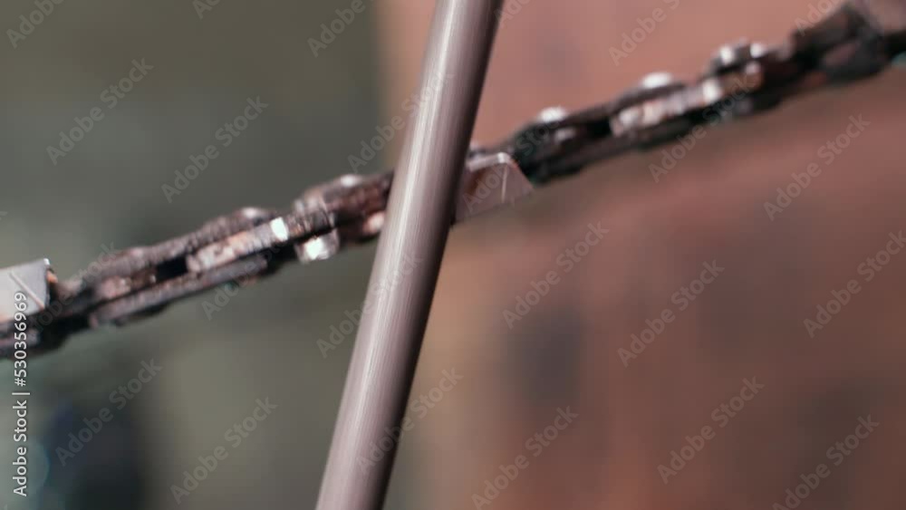 The process of sharpening chainsaw chain teeth with a round file close