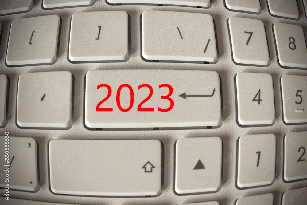 on the white keyboard a red button with the number 2023, the start of the new year on the white keyboard a red button with the number 2023, the start of the new year