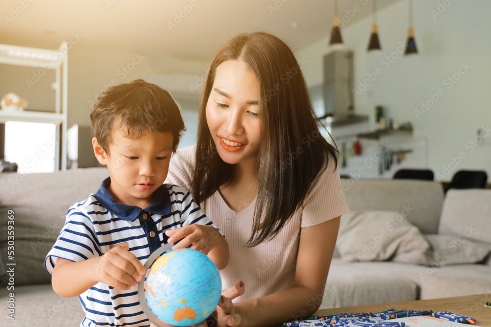 Fototapeta premium mother and child playing with globe