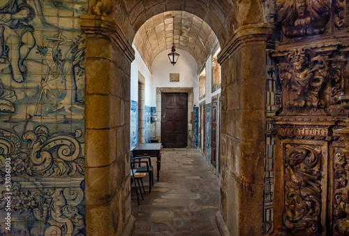 Interior of Viseu Cathedral. Mosaics with tiles and entrances with arches decorated with religious faces carved in wood