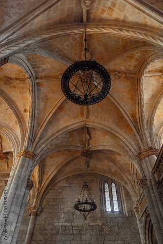 Interior of the viseu cathedral where you can see its ornate ceiling  its fabulous lamps and a wonderful stained glass window