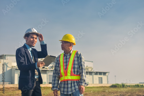 Photography Asian engineer construction team checking work for control and management in the