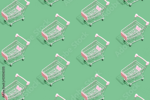 Pattern of supermarket shopping cart on green background. Creative design for packaging. Online shopping. Seamless pattern. Black friday sale concept. Copy space. Sustainable, minimalist lifestyle.
