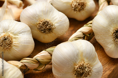 ripe garlic heads on a rustic wooden background, delicious and healthy food