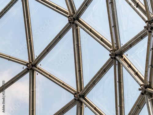 Steel and glass facade in a creative design. Architecture of an architectural dome. Building interior with a detail of the construction. Close-up of the structure of a concept.