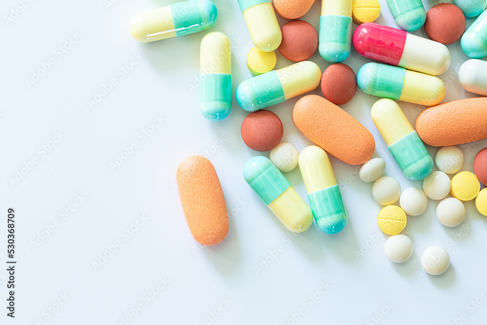 Pills and capsules on a white background,Different colorful pills on white background Pills and capsules on a white background,Different colorful pills on white background