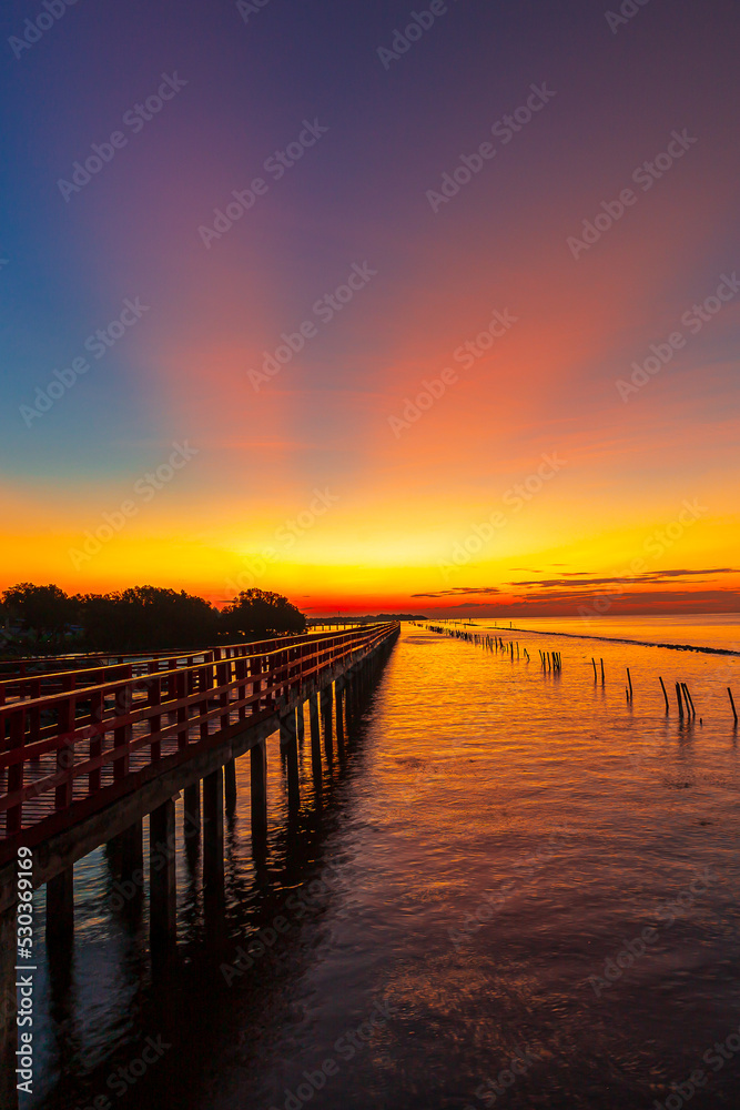 sea view and wooden bridge at sunrise,Wooden jetty on Carmolí beach at sunrise, in Cartagena, Region of Murcia, Spain