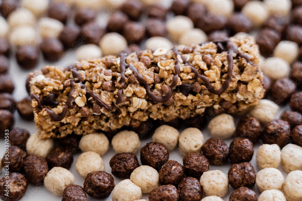 close up view of granola bar on cereal balls with vanilla and chocolate flavors. close up view of granola bar on cereal balls with vanilla and chocolate flavors.