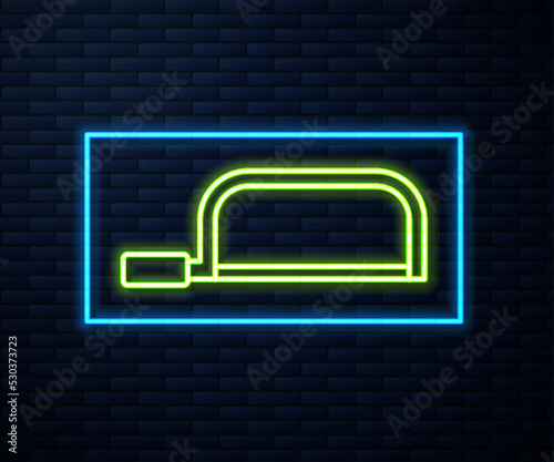 Glowing neon line Hacksaw icon isolated on brick wall background. Metal saw for wood and metal. Vector