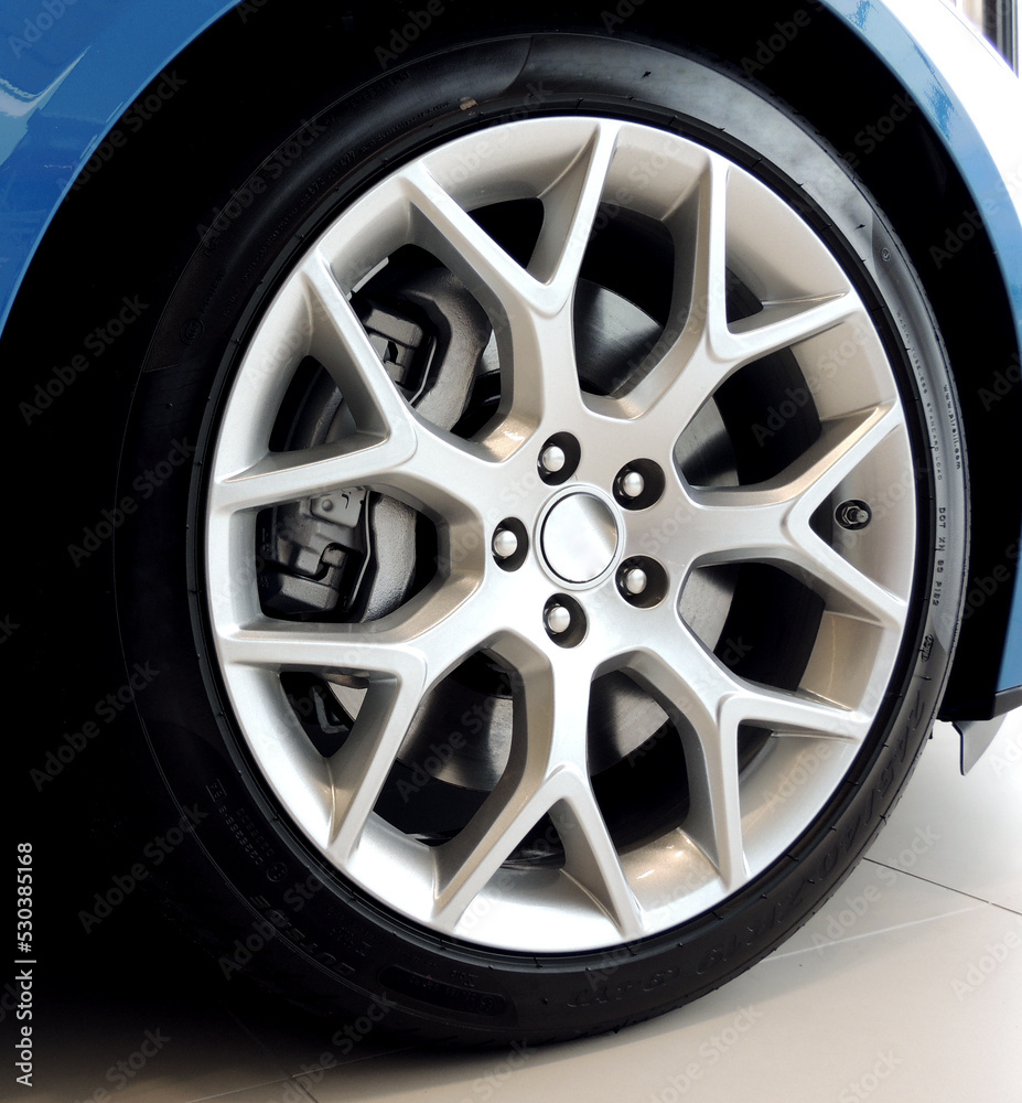 Low profile tire on multi-spoke sports vehicle rim angle view Low profile tire on multi-spoke sports vehicle rim angle view
