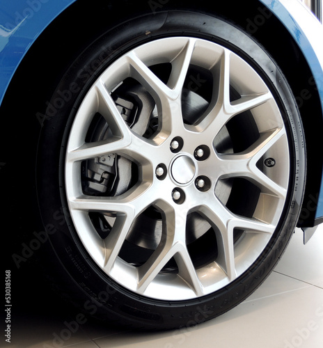 Low profile tire on multi-spoke sports vehicle rim angle view © AnyVIDStudio