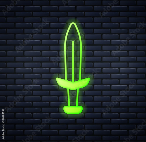 Glowing neon Medieval sword icon isolated on brick wall background. Medieval weapon. Vector