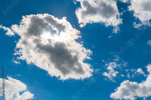 Clouds illuminated by the sun from behind. ummer sky. The sun is behind the cloud. photo