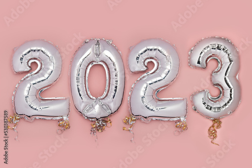 Balloon Bunting for celebration of New Year 2023 made from Silver Number Balloons. Holiday Party Decoration or postcard concept with top view and copy space.