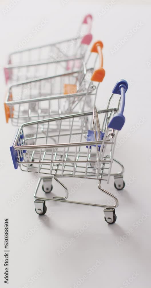 Vertical video of three shopping carts on white background Vertical video of three shopping carts on white background